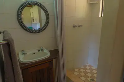 a bathroom with a sink and a mirror at Gallery Inn in Bela-Bela