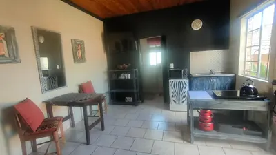 a kitchen with a table and a counter top at Tranquility Guest House in Sabie