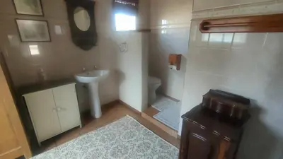 a small bathroom with a sink and a toilet at Tranquility Guest House in Sabie