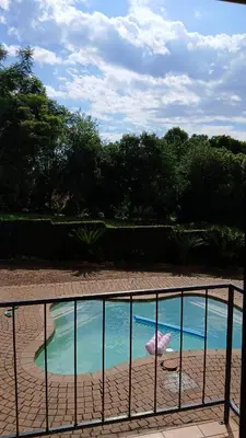 a pool of water with a fence next to it at Tranquility Guest House in Sabie