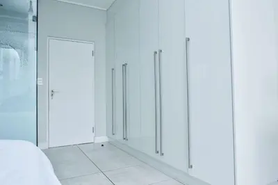 a room with white cabinets and a door at The Waterfall Retreat in Midrand