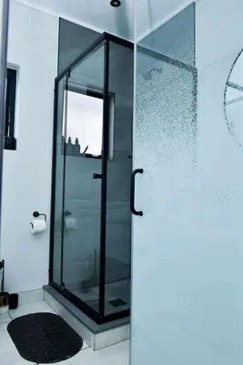 a shower with a glass door in a bathroom at The Waterfall Retreat in Midrand