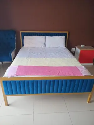 a bed in a room with a blue and pink mattress at EzekMary Res in Polokwane