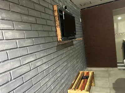 a brick wall with a window and a wooden bench at EzekMary Res in Polokwane