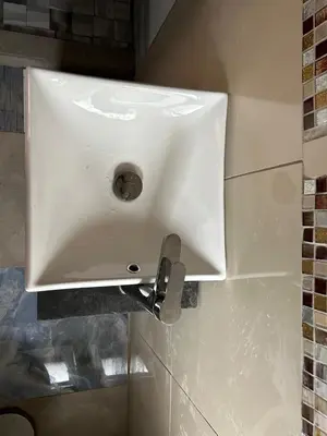 a white sink on a wall in a bathroom at EzekMary Res in Polokwane