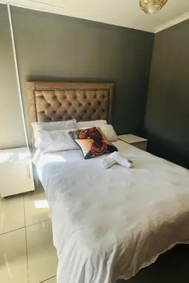 a bed with a pillow on it in a bedroom at EzekMary Res in Polokwane