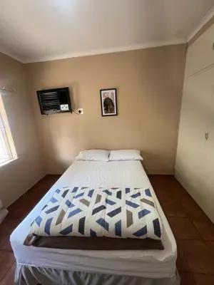 a bedroom with a large bed in a room at Happy time accommodation in Phalaborwa