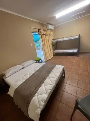 a bedroom with a large bed and a window at Happy time accommodation in Phalaborwa