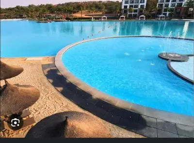 a large blue swimming pool with a fountain at The Blyde 2 and half Bedroom in Pretoria