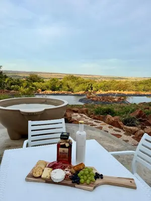 a plate of food on a table with a bath tub at Escape Pretoria East Luxury Villa in Tierpoort