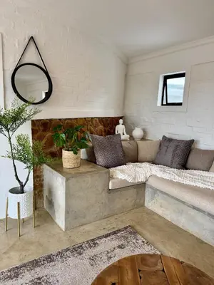 a living room with a couch and a table at Escape Pretoria East Luxury Villa in Tierpoort