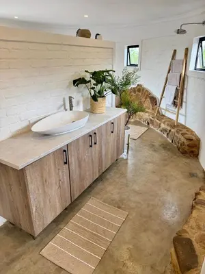 a bathroom with a sink on a counter in a room at Escape Pretoria East Luxury Villa in Tierpoort
