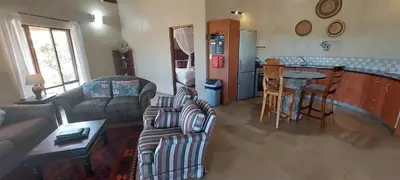 a living room with a couch and a table at Izintaba Private Game Reserve Waterberg in Vaalwater