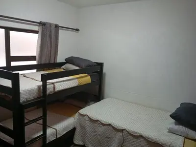 a room with two bunk beds and a window at Midrand Lodge in Midrand