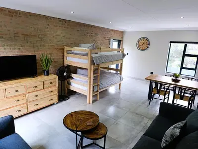 a living room with a bunk bed and a table at Joy Haven - Flat in Centurion