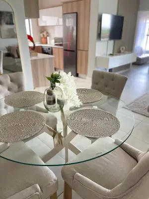 a glass table with chairs and a vase on it at The blyde tranquil lagoon view escape in Pretoria