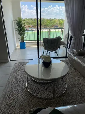 a living room with a coffee table and a balcony at The blyde tranquil lagoon view escape in Pretoria