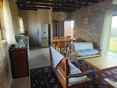 a living room with a couch and a table at Olyfburg Herberg in Tierpoort