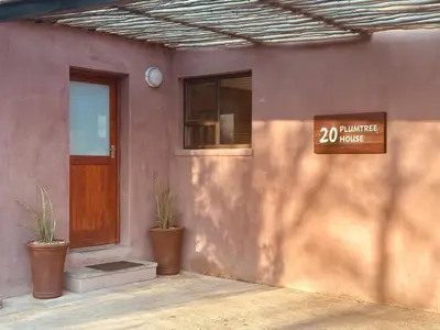 a building with a door and a sign on it at Plumtree House in Hoedspruit