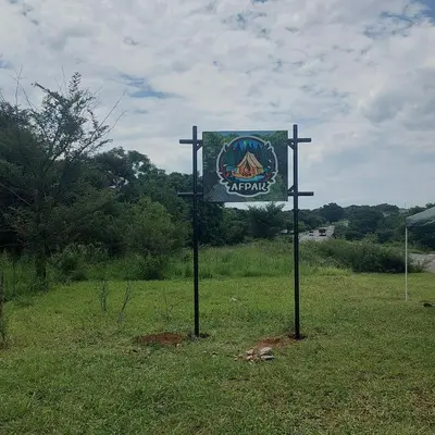 a sign in the middle of a field at Uitpak in Barberton