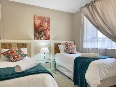 a bedroom with two beds and a window at Menlyn Place 203 in Pretoria