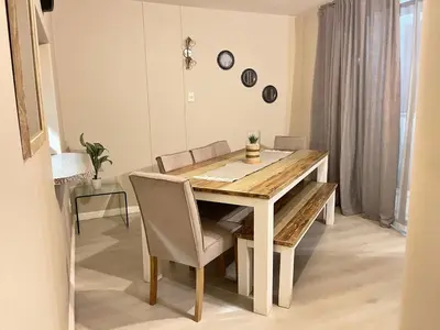 a dining room with a wooden table and chairs at Menlyn Place 203 in Pretoria