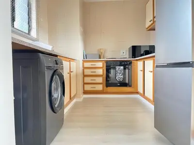 a kitchen with a washer and a dishwasher at Menlyn Place 203 in Pretoria