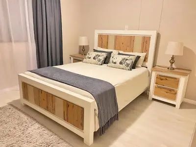 a bedroom with a large bed and two night stands at Menlyn Place 203 in Pretoria