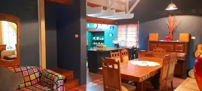 a dining room with a table and a couch at The Dutch House in Dullstroom