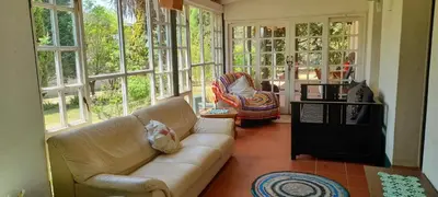 a living room with a couch and some windows at The Dutch House in Dullstroom