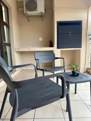 two chairs and a table on a patio at Luxe Haven in Nelspruit