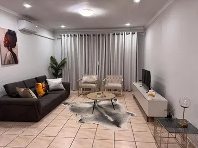 a living room with a couch and a table at Luxe Haven in Nelspruit