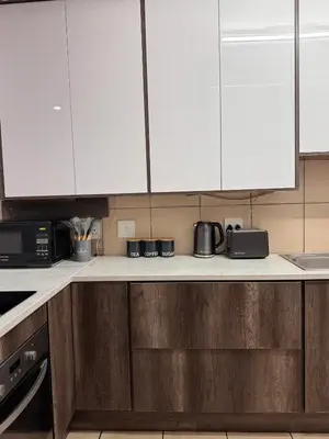 a kitchen with white cabinets and a counter top at Luxe Haven in Nelspruit