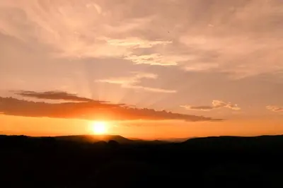 a sunset with the sun in the sky at First Group Sanbonani Resort in Hazyview