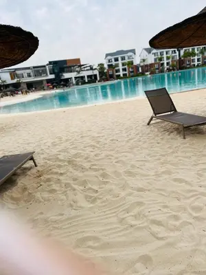 two chairs sitting on a beach near the water at The Blyde in Pretoria