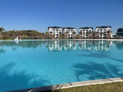 a large pool of water with houses in the background at The Blyde in Pretoria