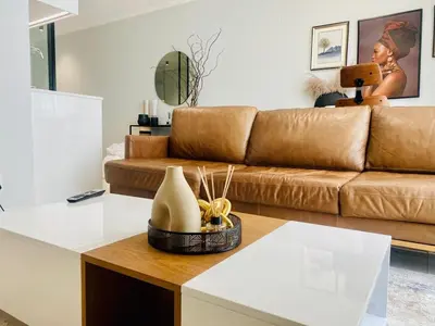 a living room with a couch and a table at KMaya at Ellipse Waterfall in Midrand