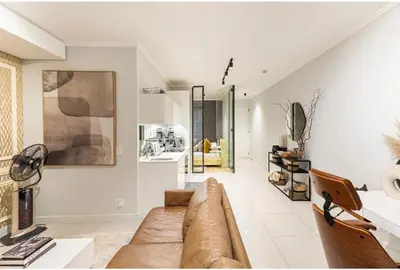 a living room with a couch and a table at KMaya at Ellipse Waterfall in Midrand