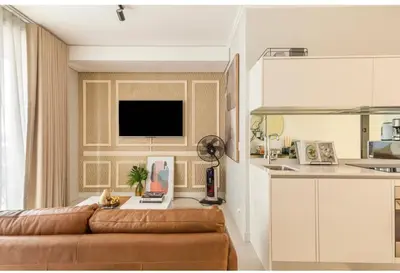 a living room with a brown couch in a kitchen at KMaya at Ellipse Waterfall in Midrand