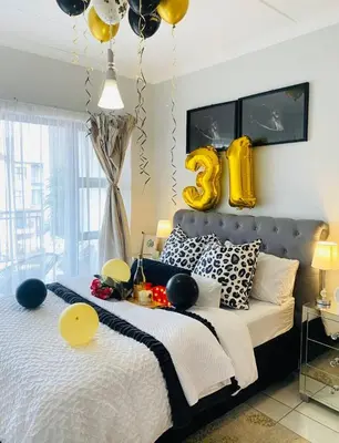 a bedroom with a large bed with inflated balloons on it at The Blyde Tranquil Mint Resort Pretoria in Pretoria