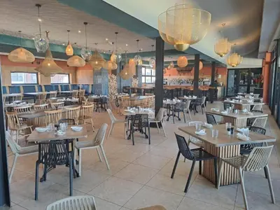 a restaurant with tables and chairs in a room at The Blyde Tranquil Mint Resort Pretoria in Pretoria