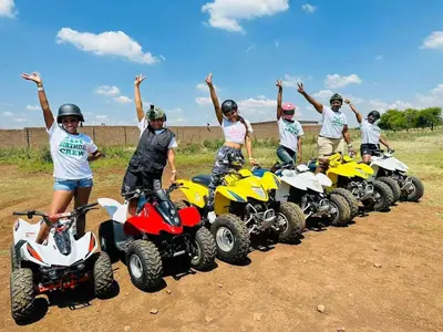 a group of people standing on atvs in a row at The Blyde Tranquil Mint Resort Pretoria in Pretoria