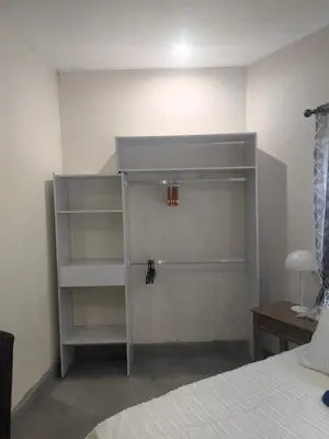 a bedroom with a bed and a gray book shelf at Villa in the Wild in Marloth Park