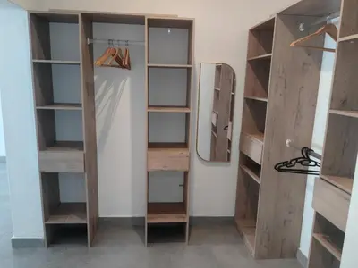 a closet with wooden shelves and a mirror at Villa in the Wild in Marloth Park
