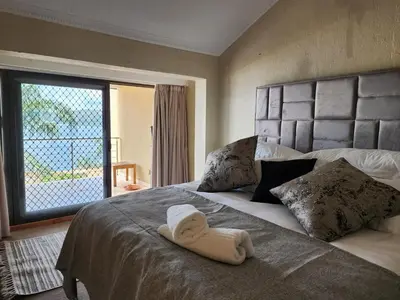 a bedroom with a bed with a towel on it at BondMakers Hidden Gem in Hartbeespoort