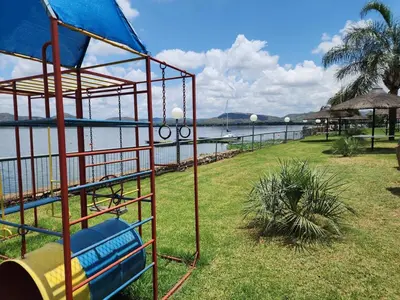 a playground with a slide next to the water at BondMakers Hidden Gem in Hartbeespoort