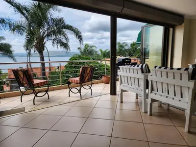 a balcony with benches and a view of the ocean at BondMakers Hidden Gem in Hartbeespoort
