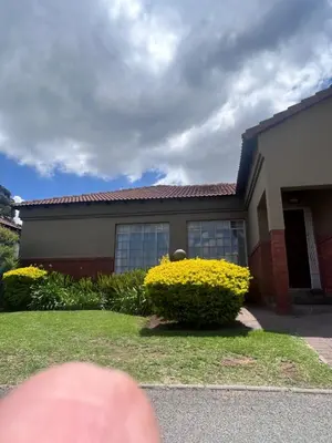 a house with yellow flowers in front of it at 3 Bed Holiday Home in Witbank