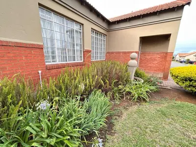 a house with a bunch of plants in front of it at 3 Bed Holiday Home in Witbank