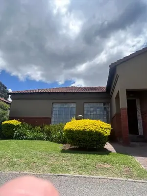 a house with yellow flowers in front of it at 3 Bed Holiday Home in Witbank